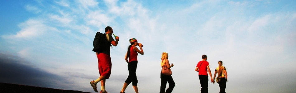 Runners silhouette against blue sky